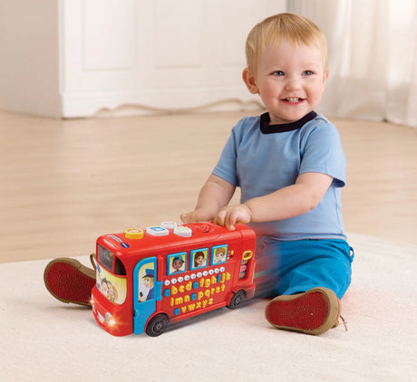 Child sitting with VTech Playtime Bus with Phonics on the floor