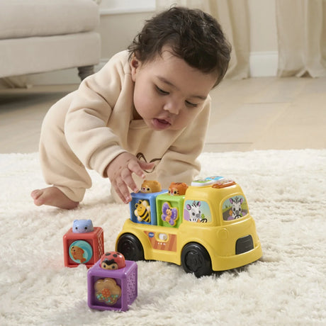 Baby playing with VTech Pop-a-Block Truck and removable animal blocks – Ireland.
