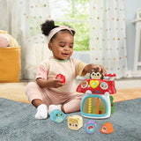 Child sitting beside VTech Pop and Play Mushroom House with six shape blocks