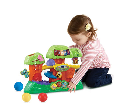 Child playing with VTech Pop and Play Activity Tree ball toy – Ireland