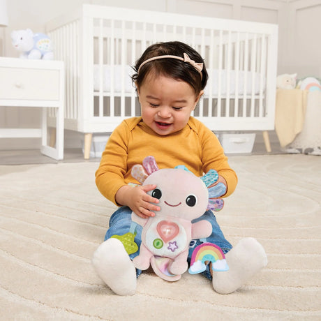 Baby playing with soft VTech Rainbow Lights Axolotl on nursery floor – Ireland.