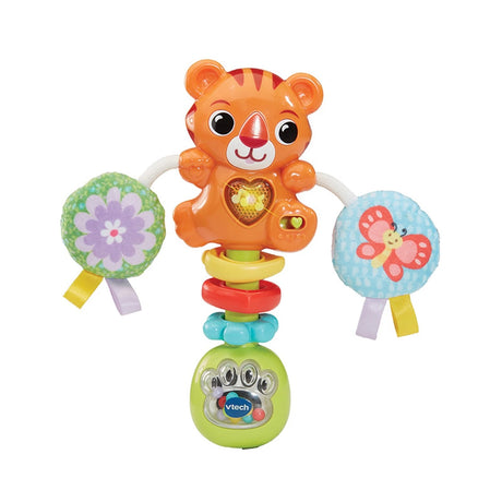 VTech Rattle & Roar Tiger baby rattle with orange tiger character, clear bead filled base, green handle and two round fabric pom pom discs attached by white cord
