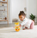 Child crawling beside VTech Rock and Roll Bear with light-up base