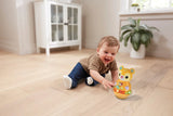 Child sitting beside VTech Rock and Roll Bear with light-up base