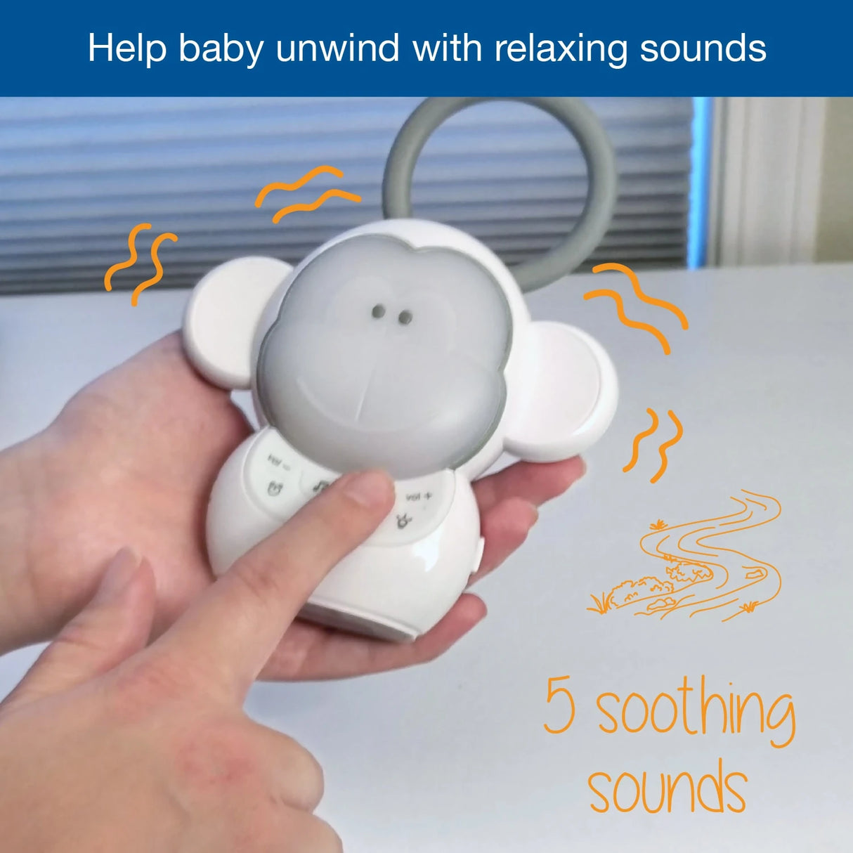 Hand pressing the VTech Myla the Monkey Portable Soother controls with a 5 soothing sounds graphic