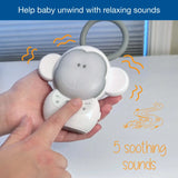 Hand pressing the VTech Myla the Monkey Portable Soother controls with a 5 soothing sounds graphic