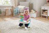 Child seated in a floor seat with the VTech Sing-Along Spinning Wheel attached to the tray 