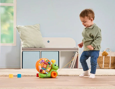 Toddler pulling VTech Spinning Activity Snail toy on string – Ireland
