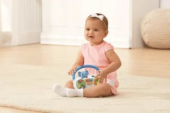 Baby playing with VTech Take Along Tunes Radio Toy on the floor – Ireland