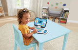 Child sitting at a blue table with VTech Toddler Tech Laptop open