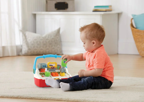 Toddler playing with VTech Tool Box Friends toy tools on floor – Ireland