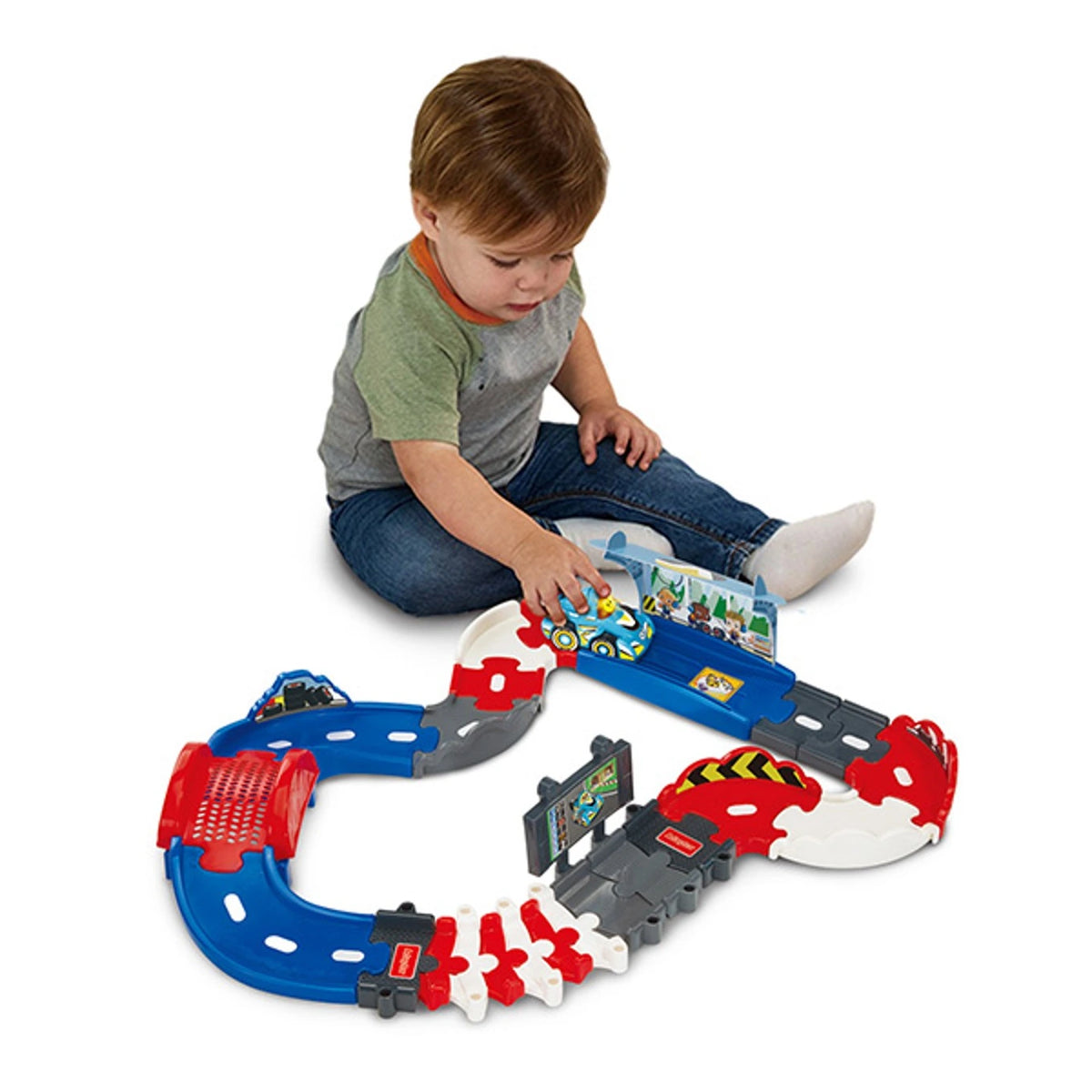 Child playing with the VTech Toot-Toot Drivers V Racers Pit Stop, blue racer, bridge and track