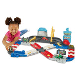 Child playing with the VTech Toot-Toot Drivers V Racers Race Track with green, red and black racers on the connected track
