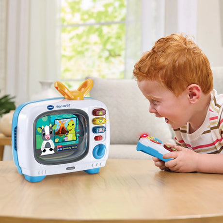 Child playing with VTech Tune In TV using magic remote control – Ireland.