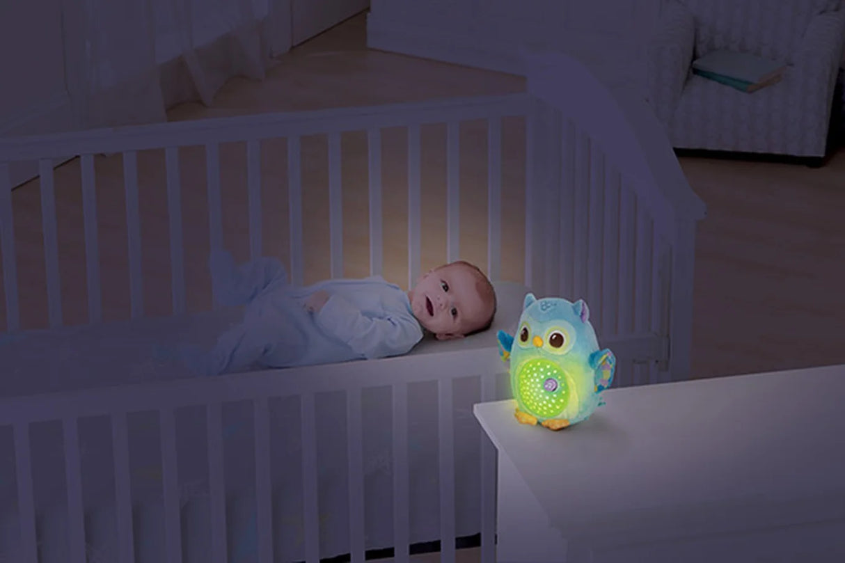 Baby with VTech Twinkle Lights Owl soft toy glowing in room – Ireland