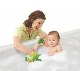 Toddler in bath playing with VTech Wind and Go Turtle Toy – Ireland