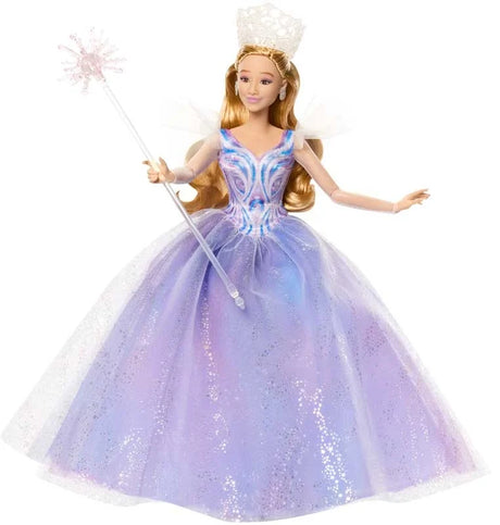 Glinda doll posed holding wand and wearing tiara, styled in multi-layer gown with flutter sleeves and curled blonde hair