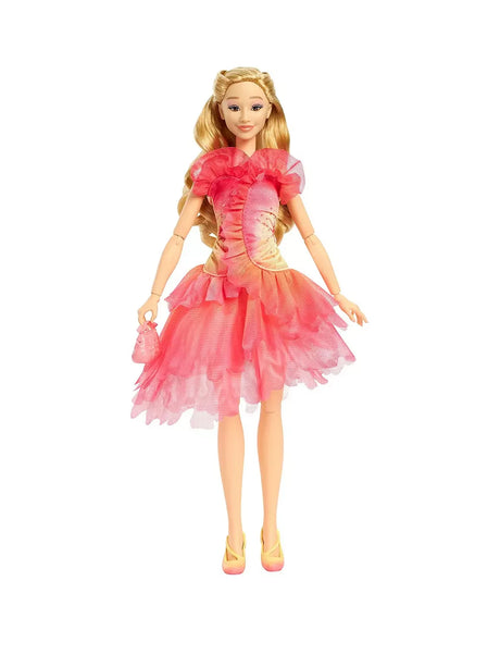 Glinda doll standing in her pink layered dress with long blonde hair styled and her matching pink handbag held at her side
