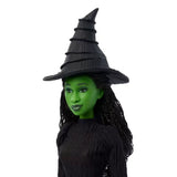 Close-up of Elphaba doll from Wicked wearing her signature black hat with braided hair and green skin clearly visible