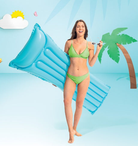 Woman holding blue Intex Economat pool float, smiling in summer setting, Ireland
