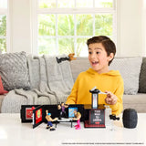 Child playing with WWE Knuckle Crunchers Microphone Playset transformed into backstage arena in Ireland.