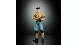 WWE WrestleMania Elite John Cena action figure front view in blue shorts and orange cap with wristbands, posed with a salute gesture