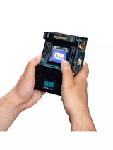 Two hands holding the WWE WrestleMania Handheld Electronic Arcade Game, showing the compact size of the mini cabinet with colour screen displaying gameplay