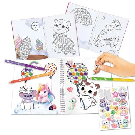Ylvi Pop and Paint Colouring Book spread open showing dot-art colouring pages, completed full-colour illustrated pages, coloured pencils and a sheet of character stickers