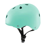 Green Yvolution kids helmet side view with round vents and black straps on a clean white background