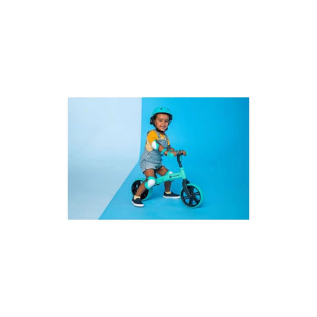Child sitting on Yvolution Velo Junior Balance Bike Green