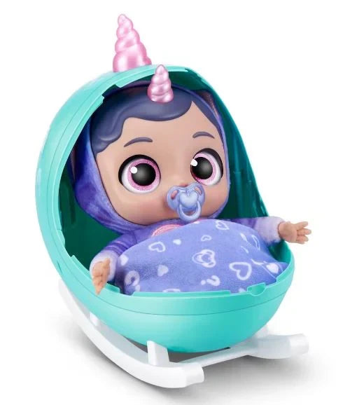 Purple themed Babycorn doll with pink unicorn horn sitting inside opened teal egg cradle with matching blanket and pacifier