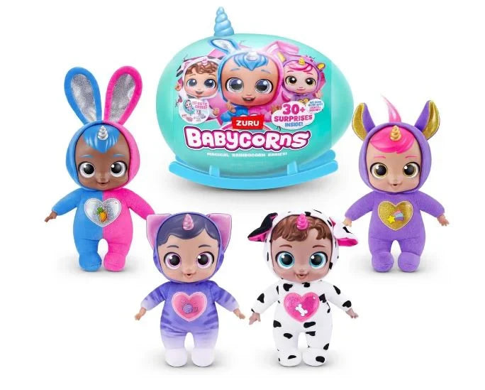 Five Babycorn dolls in animal and unicorn themed outfits standing in front of teal Babycorns Surprise egg on white background